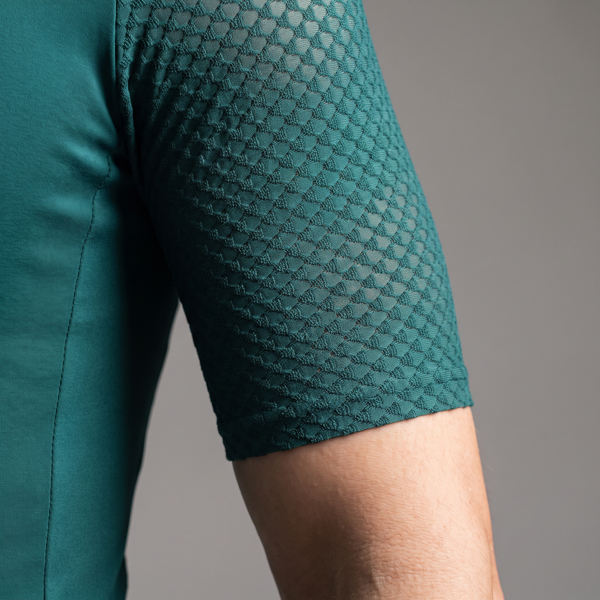 Close up of the textured jacquard mesh sleeve and raw cut hem