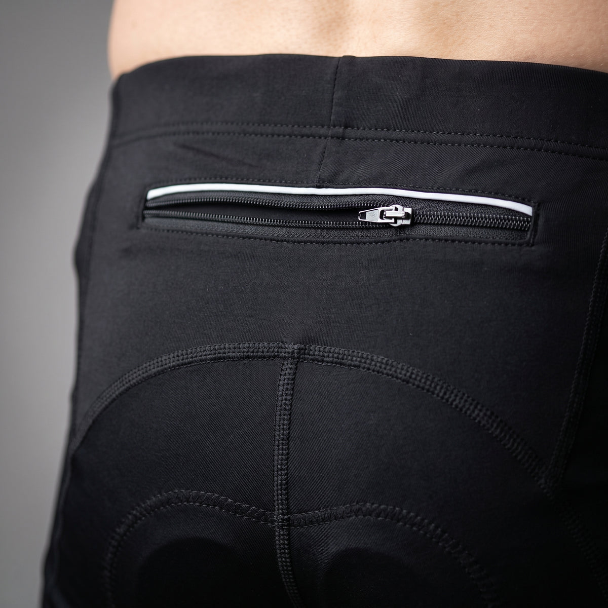Close up of the zipped rear pocket with reflective strip