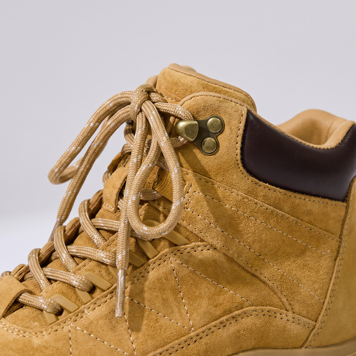 Close-up of the suede upper, brass eyelets and speed hooks of the Women's Walking Boots in Wheat