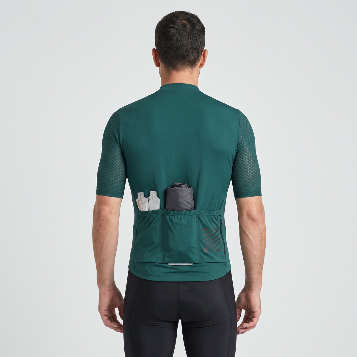 Rear pockets loaded with a packable jacket and gels, hem holding level