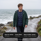 Man on a coastal path wearing the Men's Puffer Jacket under a waterproof, down filled, about 300 g, new for winter 2026