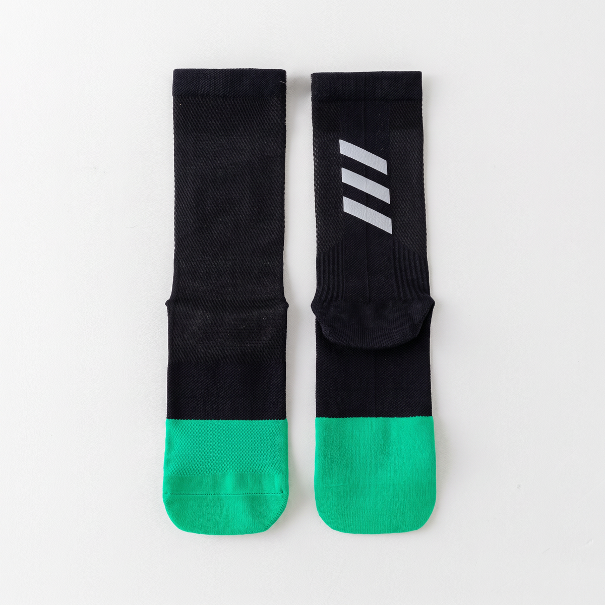 Cycling socks, pair laid flat, showing the reflective bars on each cuff