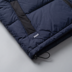 Close-up of the black bound armhole, drawcord toggle and 700 fill power mark