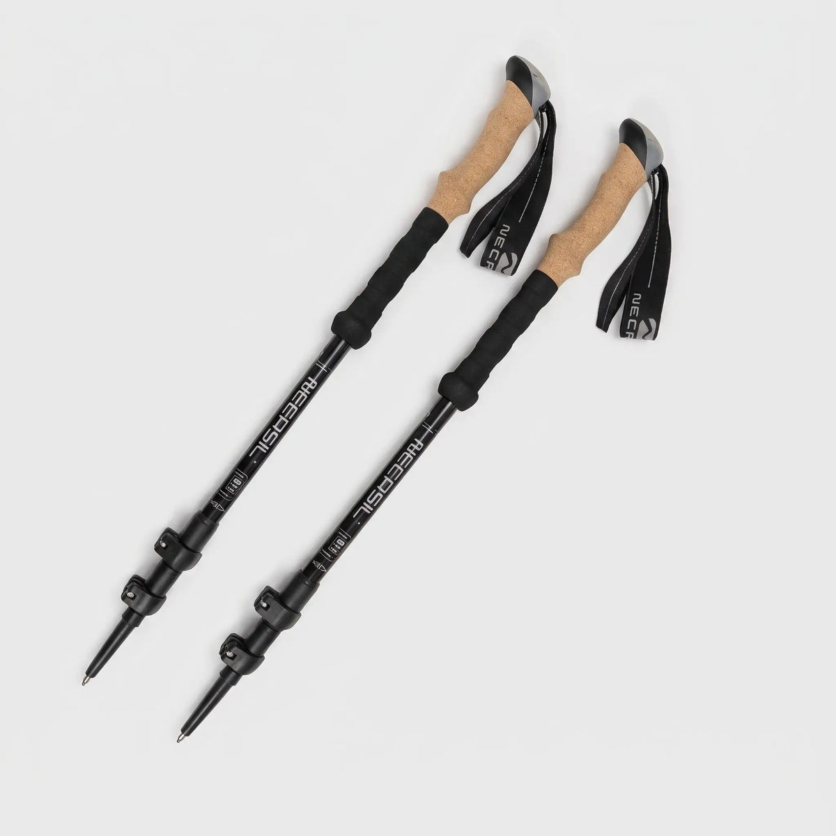 Pair of black trekking poles with cork grips and lever locks