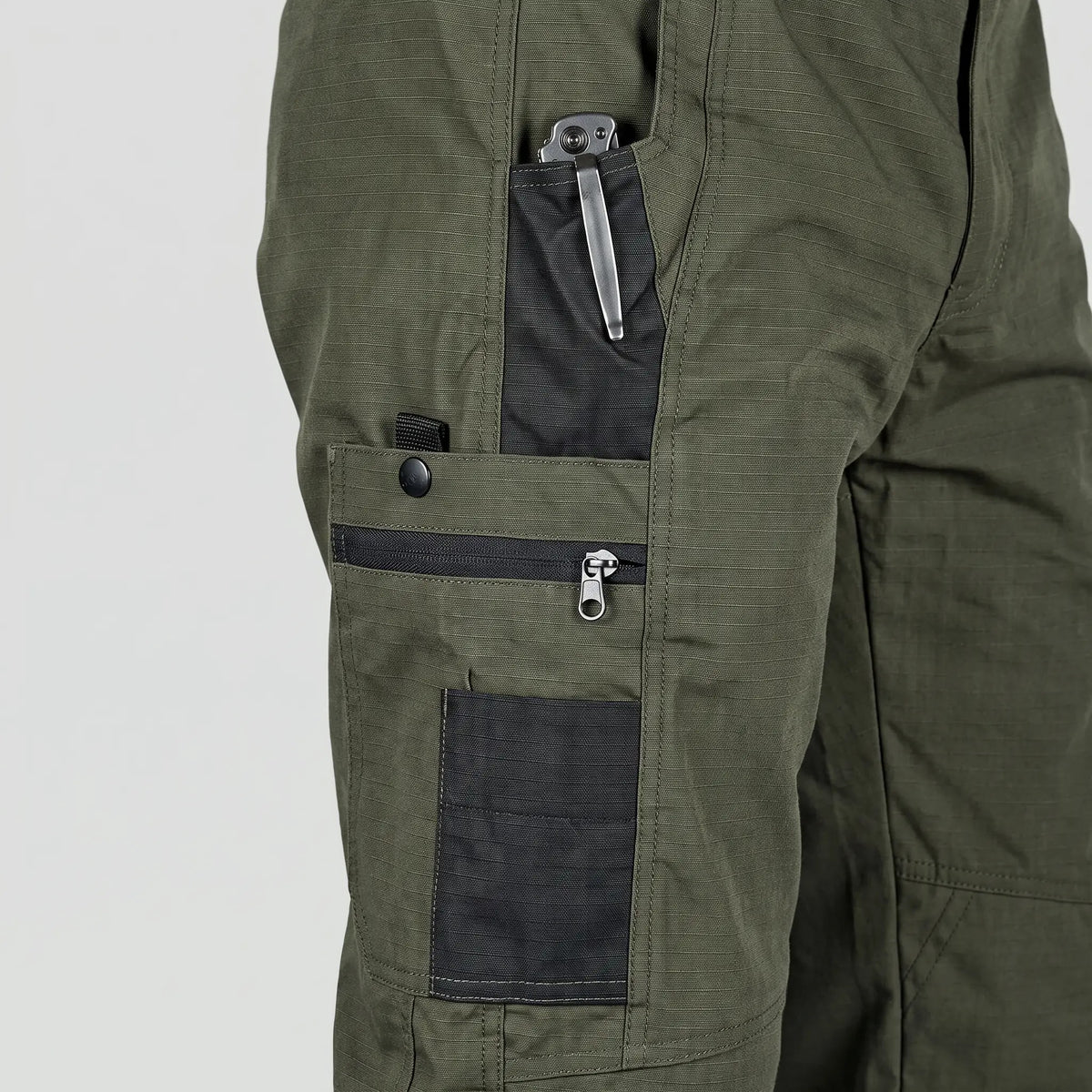 Close-up of the thigh pockets with zip pocket, phone pocket and pen slot