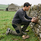 Man kneeling at a dry-stone wall in Army Green work trousers