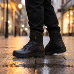 Black combat boots on a wet city pavement in the evening