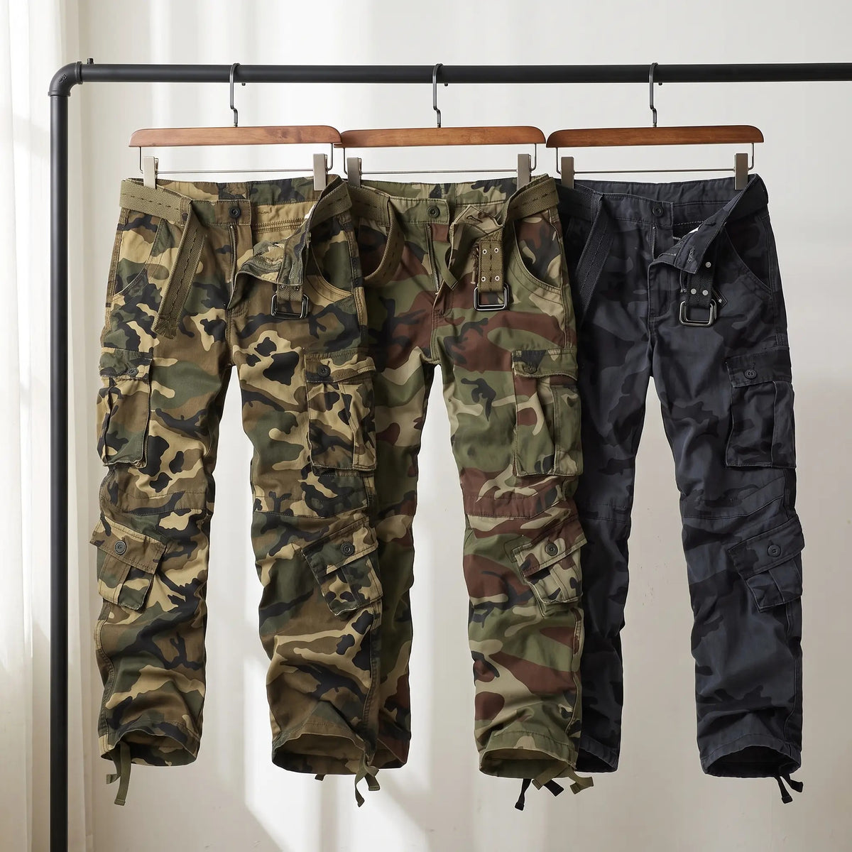 Camo cargo trousers in Olive Green, Army Green and Blue on a rail