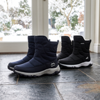 Men's snow boots in Navy and Black in a porch