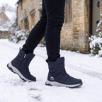 Men's snow boots in Navy worn on a snowy village pavement
