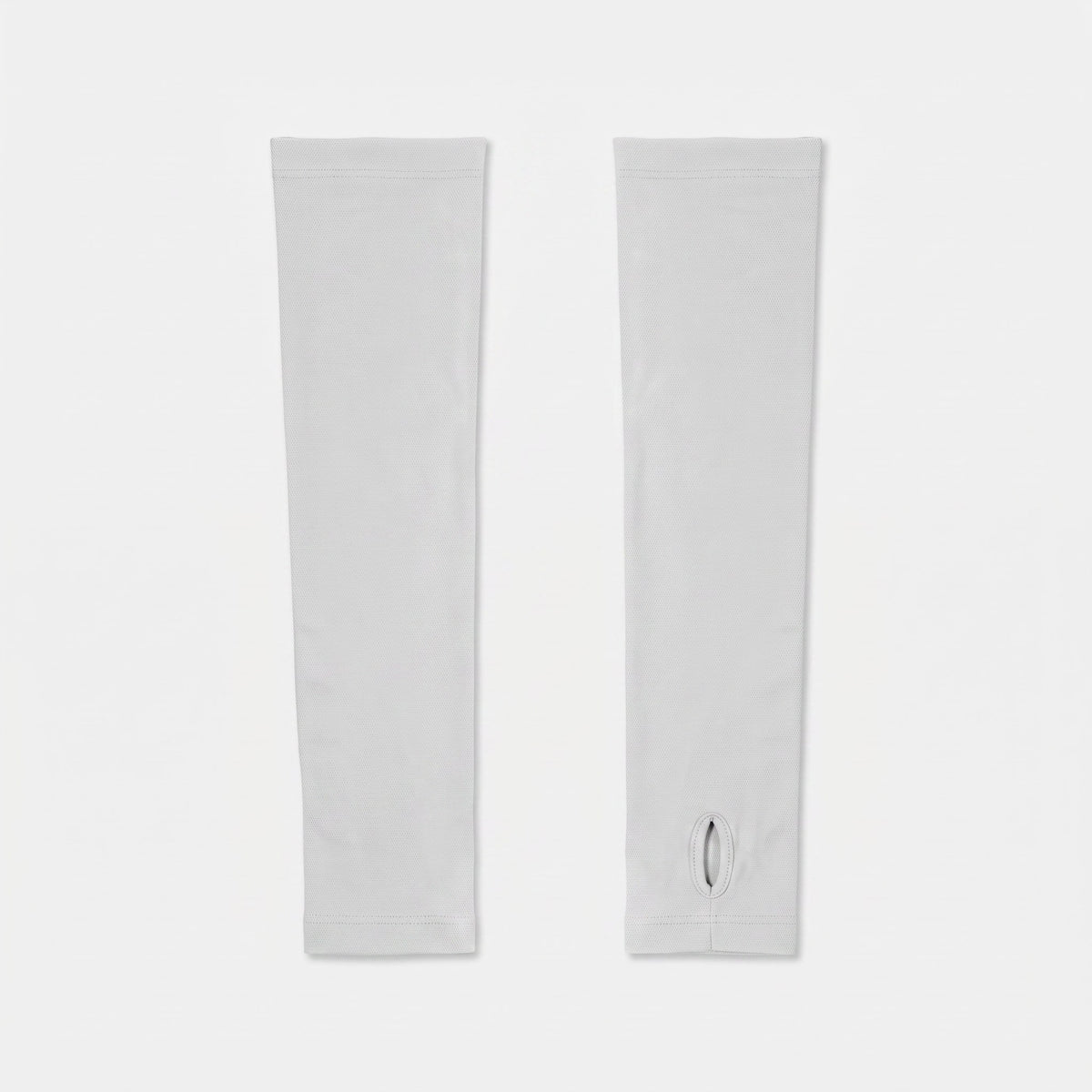 The two sleeve styles side by side: a plain cuff ending at the wrist, and a thumb loop continuing over the back of the hand