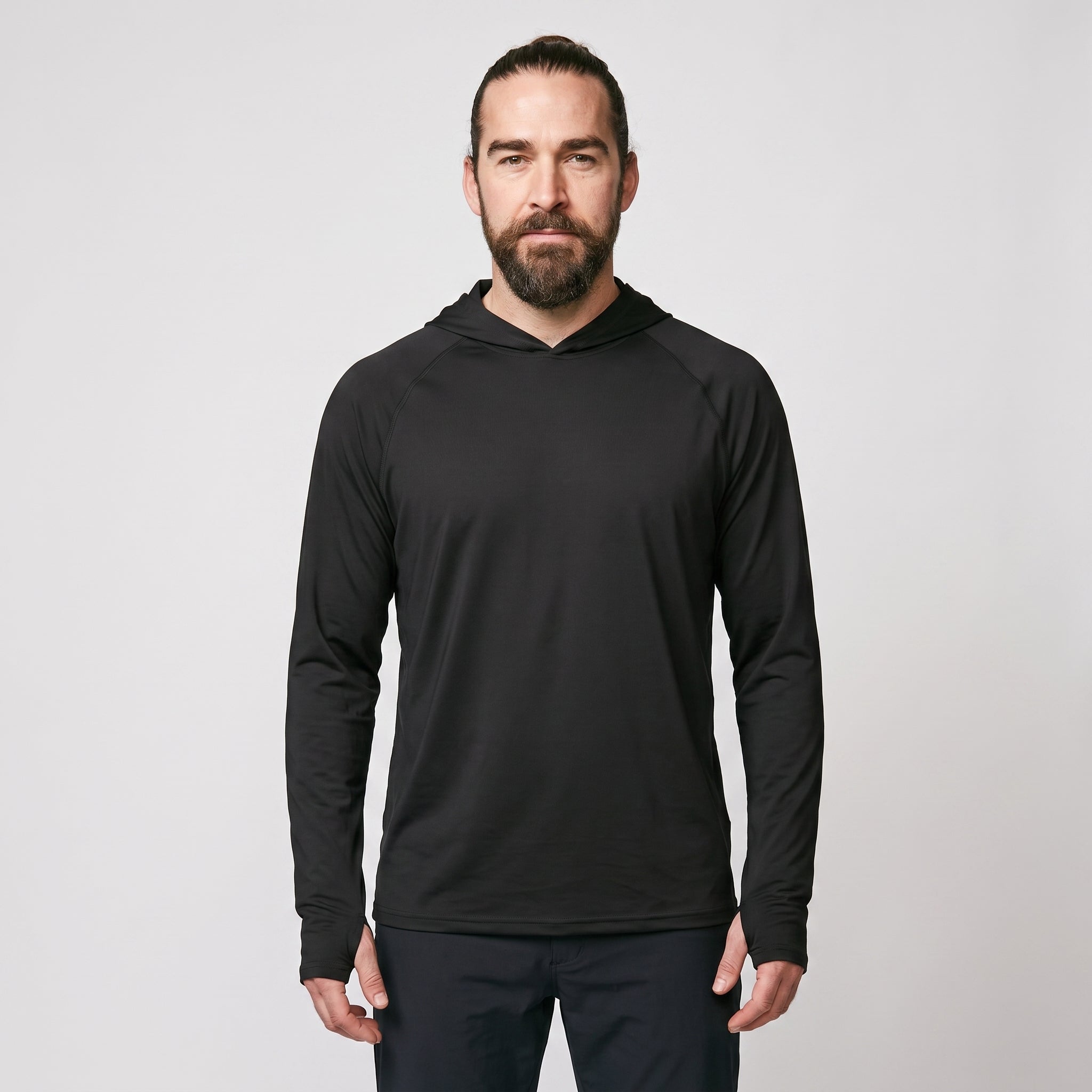 Man wearing black UPF 50+ sun hoodie, front view, hood down