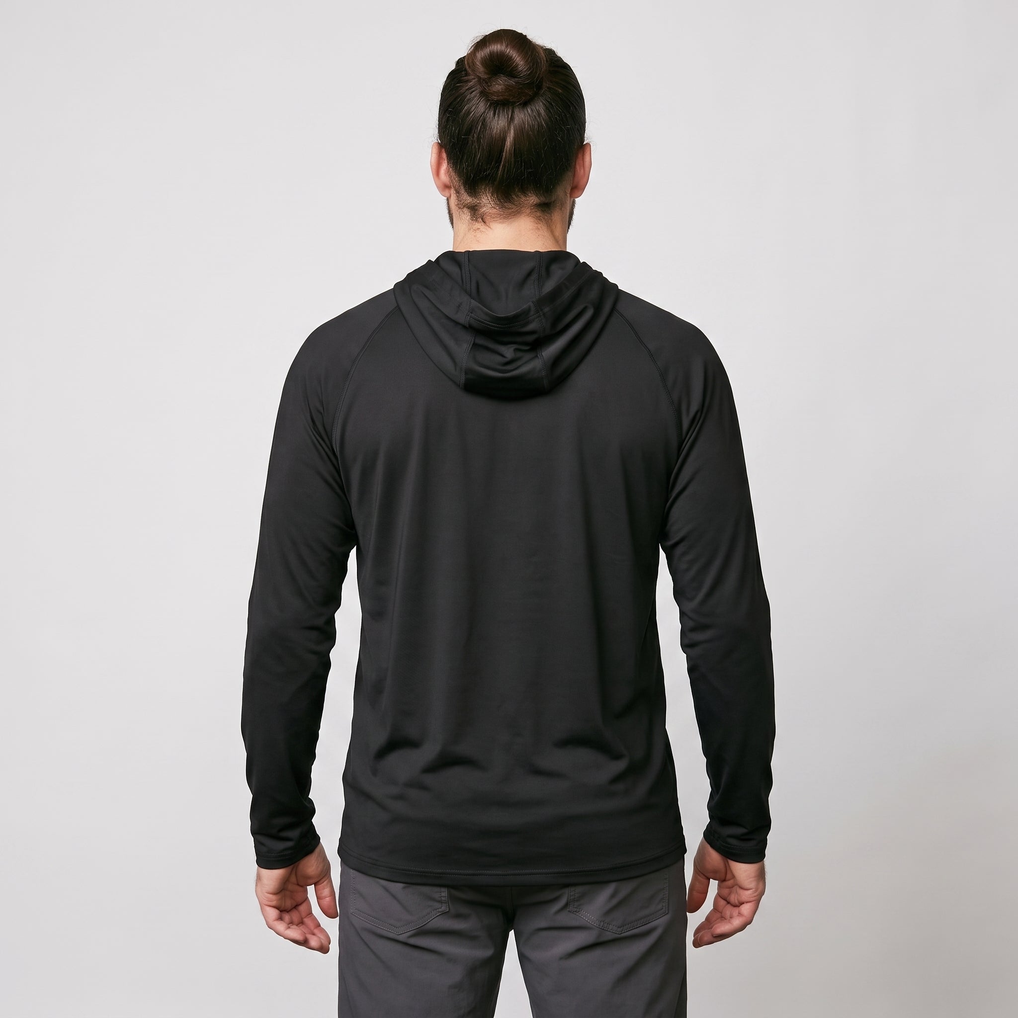 Man wearing black UPF 50+ sun hoodie, full back view