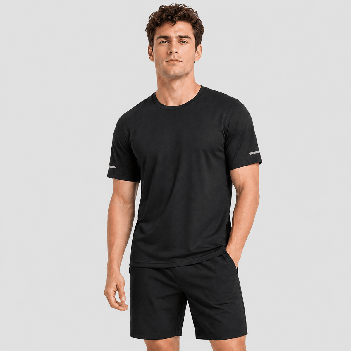 Man wearing the men's running top in Black, front view