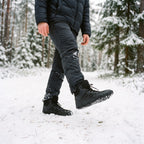 Man walking through fresh snow in the fleece lined barefoot boots in Black