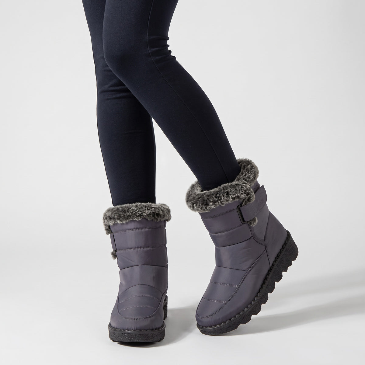 Grey fur lined winter boots worn with leggings