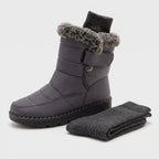 Fur lined winter boot beside a pair of wool socks