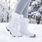 White faux fur snow boots worn in fresh snow in a park
