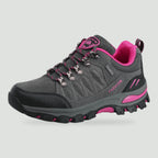 Women's hiking shoe in Grey with pink accents, side view