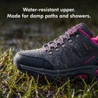Water droplets beading on the water-resistant upper of the hiking shoes in wet grass