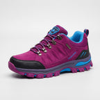 Women's hiking shoe in Pink with blue accents, side view