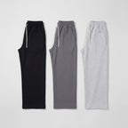 Men's wide leg joggers in Black, Grey and Light Grey laid flat side by side