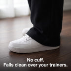 Open hem of the men's joggers falling over a white trainer with no cuff
