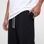 Phone sliding into the deep side pocket of the Black jogging bottoms