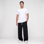 Man wearing the Black men's joggers with a white t-shirt, full length front view