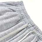 Close-up of the gathered elastic waistband and flat white drawcord