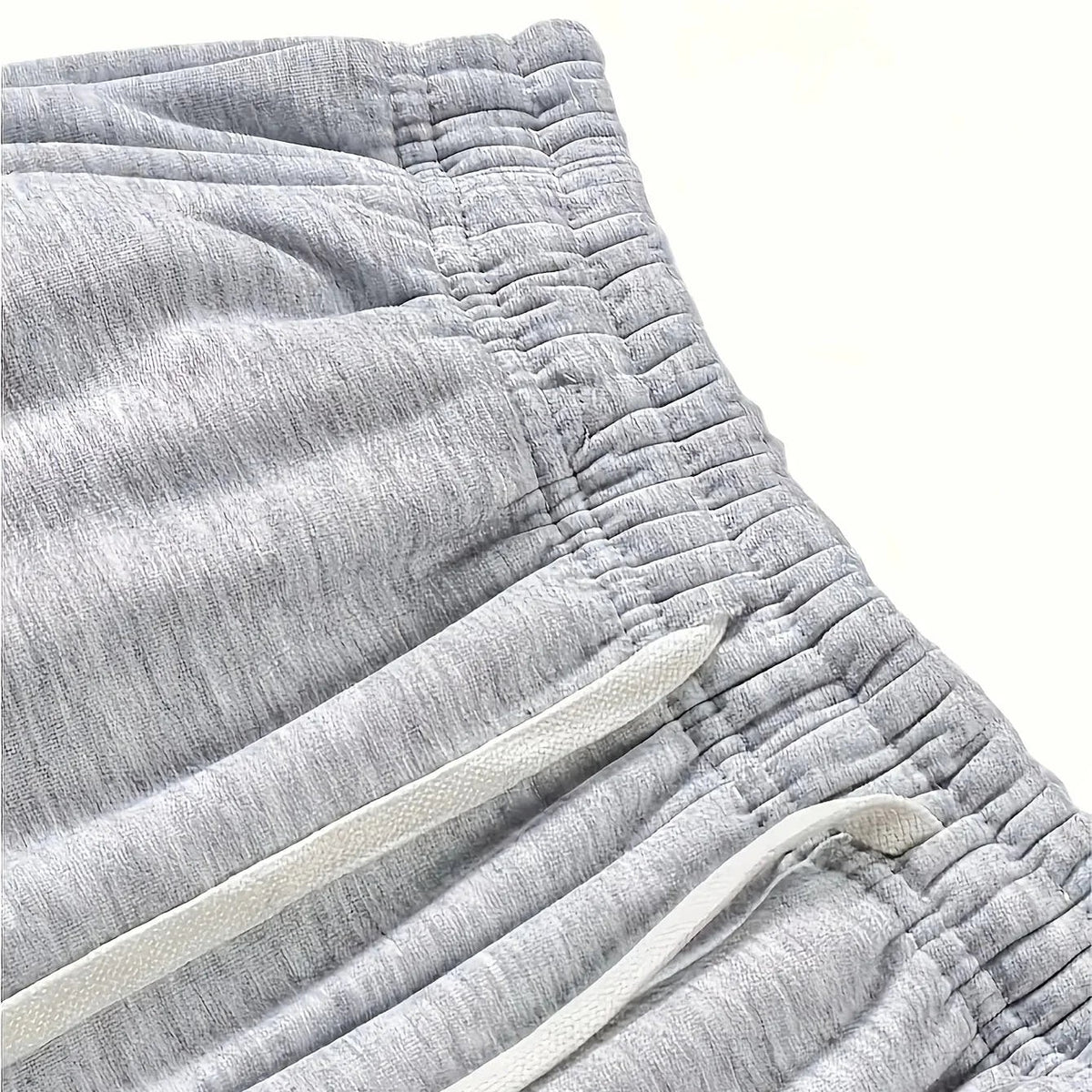 Close-up of the gathered elastic waistband and flat white drawcord