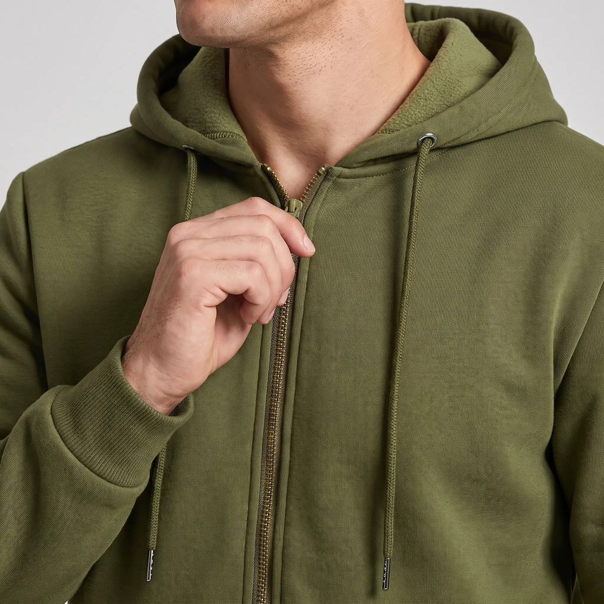 Close-up of the zip, drawcords and hood collar of the men's zip up hoodie