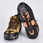 Microspikes fitted on a pair of walking boots, one sole turned up to show the spikes