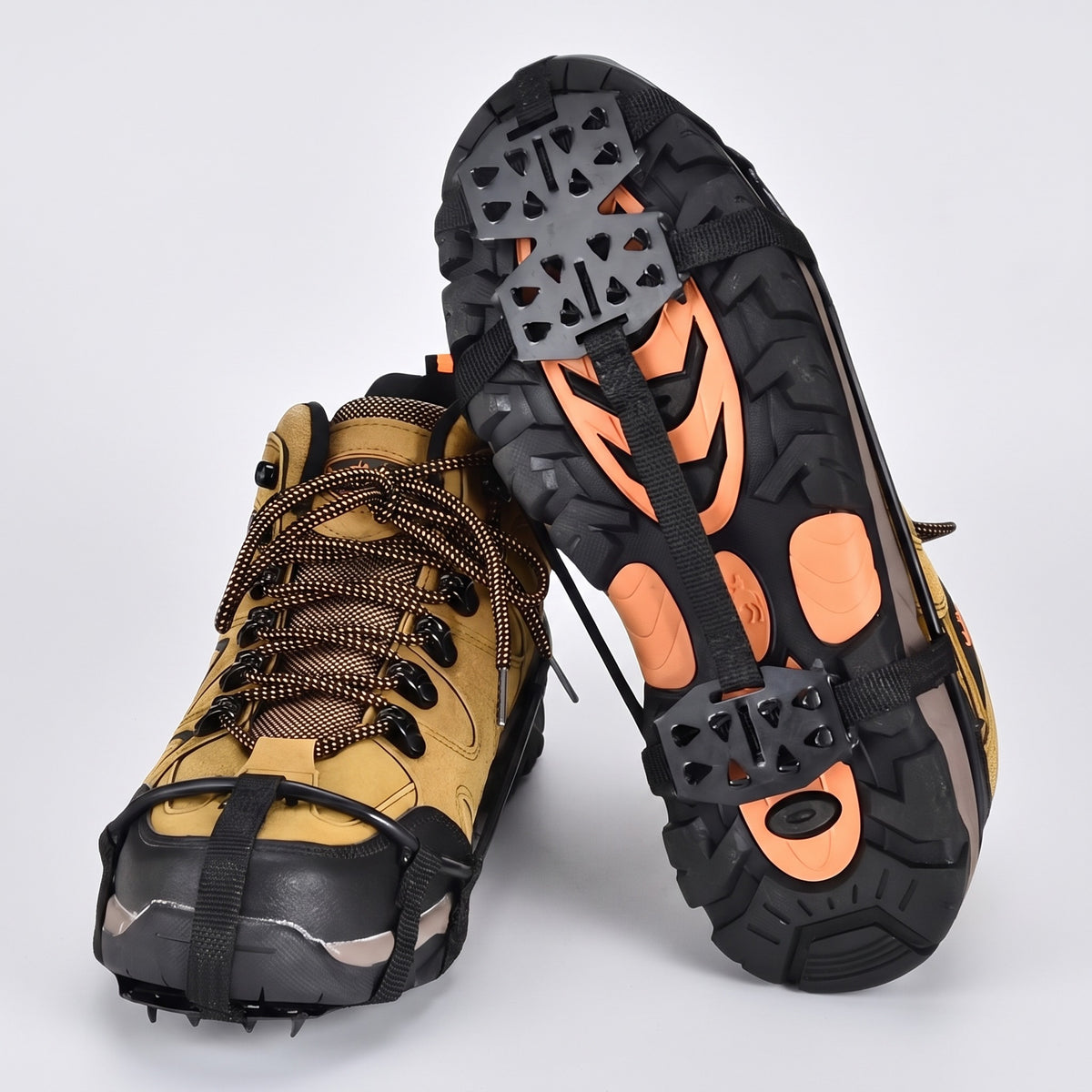 Microspikes fitted on a pair of walking boots, one sole turned up to show the spikes