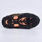 Underside of a walking boot with microspikes, spike plates under the forefoot and heel