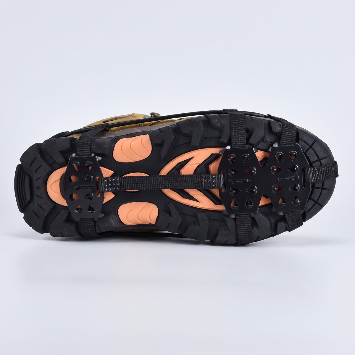 Underside of a walking boot with microspikes, spike plates under the forefoot and heel