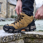 Pulling the heel loop of the microspikes over a walking boot