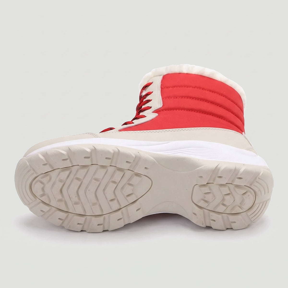 Underside of the platform snow boot showing the full lugged rubber outsole