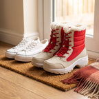 Red platform snow boots beside a pair of canvas trainers to show the platform height