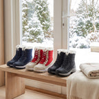 Navy, Red and Black platform snow boots lined up on a porch bench