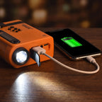 LED torch lit on the end of the shortwave radio while it tops up a phone by USB