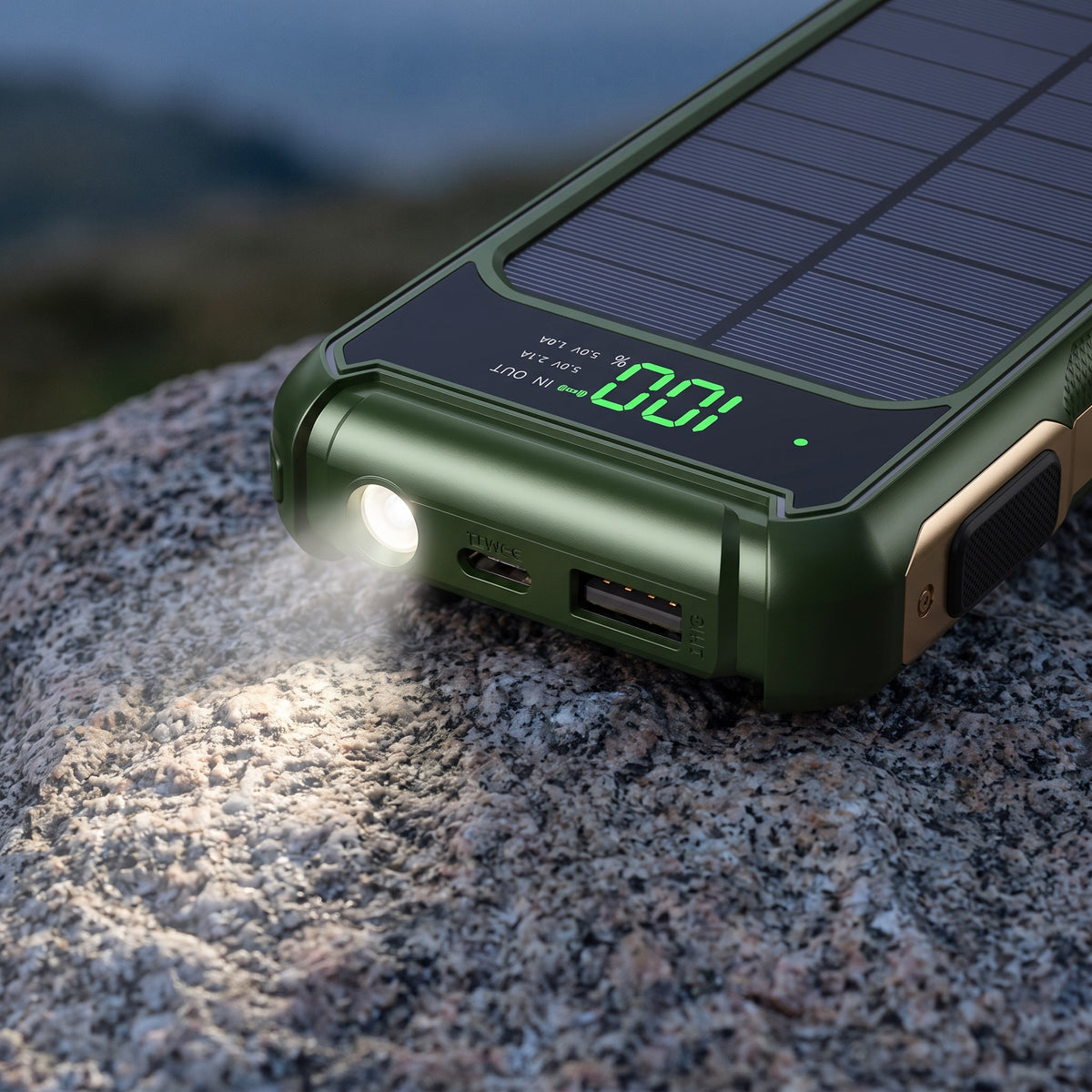 Solar power bank display reading 100 percent with the LED torch on at dusk