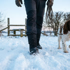 Man on a snowy dog walk in the Black toggle lace snow boots