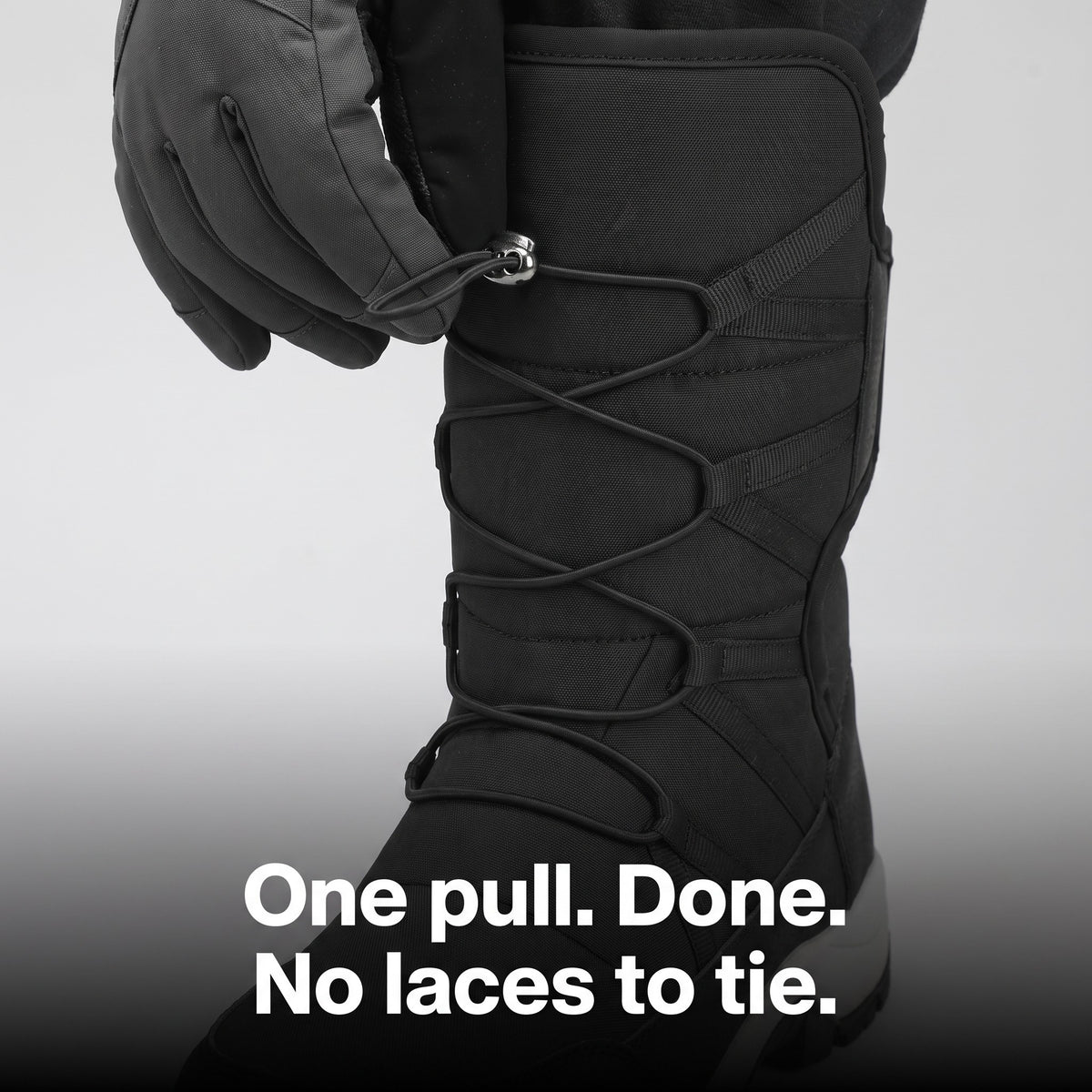 Gloved hand pulling the toggle lace: one pull, no laces to tie