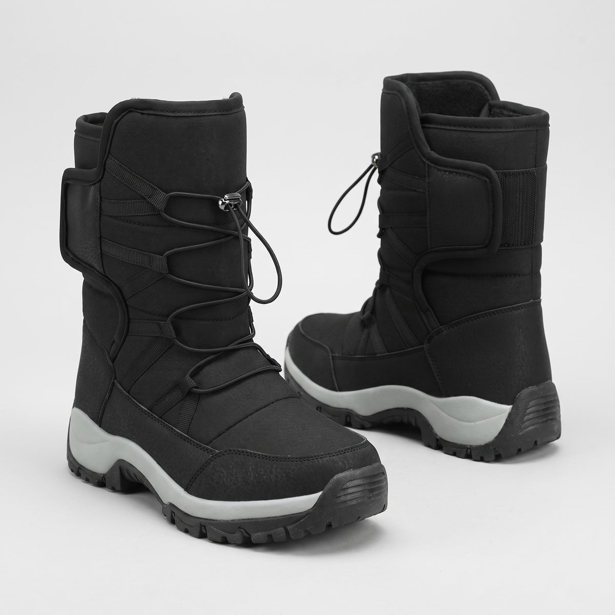 Black fur lined snow boots with toggle lace and collar strap