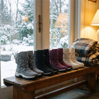 Grey, Black, Plum and Off-White snow boots lined up on a porch bench