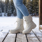 Off-White winter boots for women worn with jeans on a snowy cabin deck