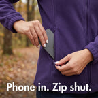 Phone going into the zipped side pocket of the women's fleece: Phone in. Zip shut.