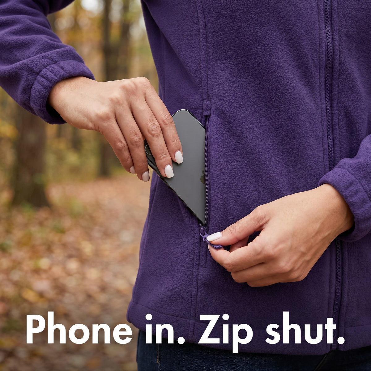 Phone going into the zipped side pocket of the women's fleece: Phone in. Zip shut.