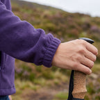 Gathered elastic cuff of the fleece at the wrist on a trekking pole